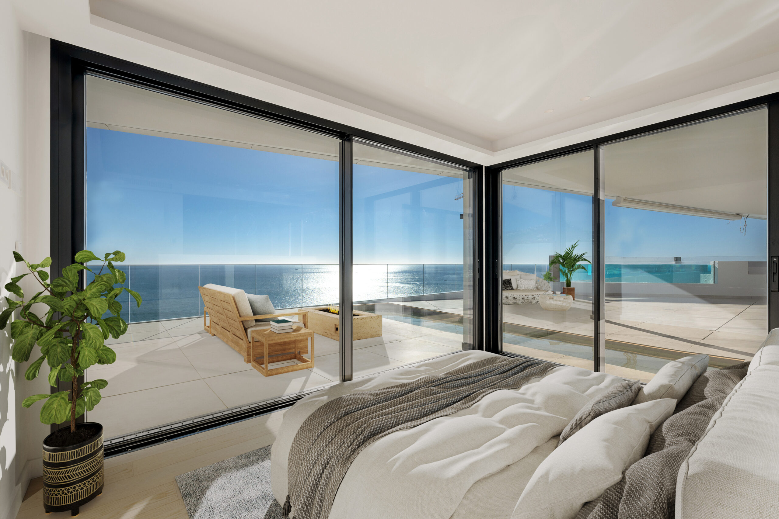 Dormitorio luminoso con grandes ventanales y acceso a una terraza con vistas al mar.